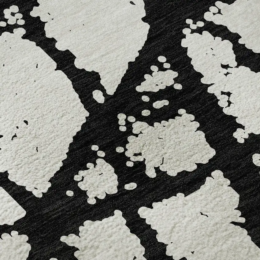 8' Black And Ivory Abstract Washable Round Rug With UV Protection Photo 8