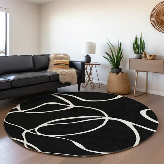 8' Black And Ivory Abstract Washable Round Rug With UV Protection Photo 4