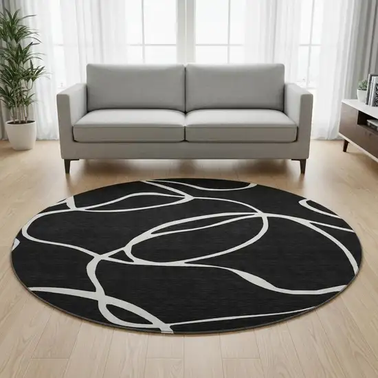 8' Black And Ivory Abstract Washable Round Rug With UV Protection Photo 2