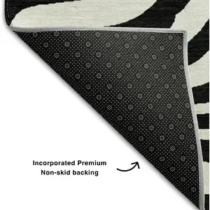 Photo of 8' Black And Ivory Animal Print Washable Round Rug With UV Protection