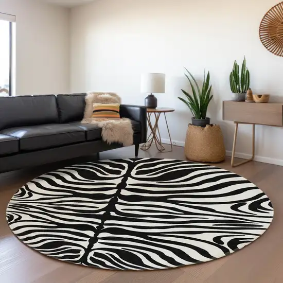 8' Black And Ivory Animal Print Washable Round Rug With UV Protection Photo 3