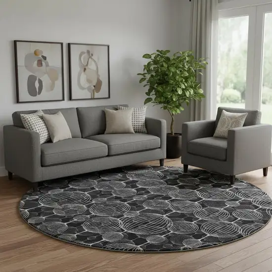8' Black And Ivory Geometric Washable Round Rug With UV Protection Photo 1