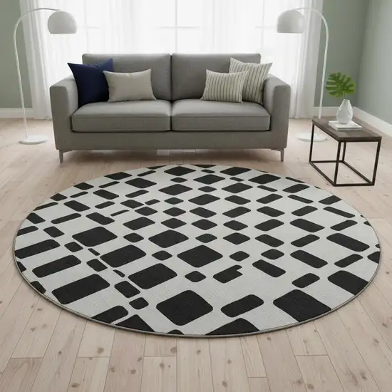 8' Black And Ivory Geometric Washable Round Rug With UV Protection Photo 2