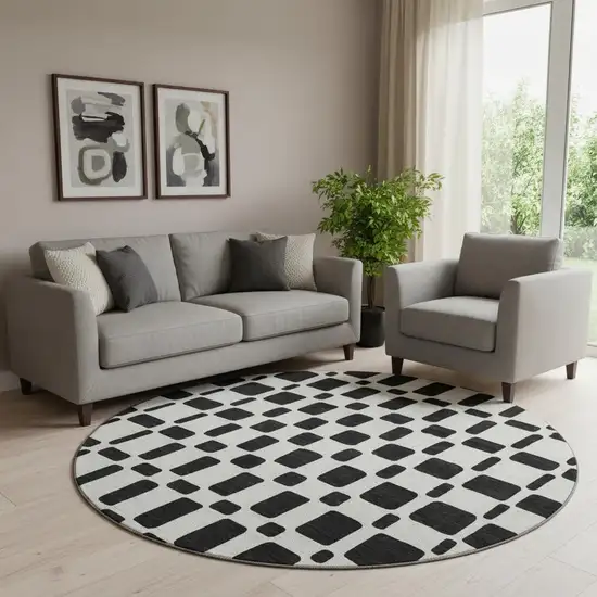 8' Black And Ivory Geometric Washable Round Rug With UV Protection Photo 1