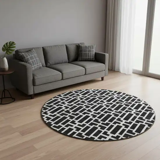 8' Black And Ivory Geometric Washable Round Rug With UV Protection Photo 2