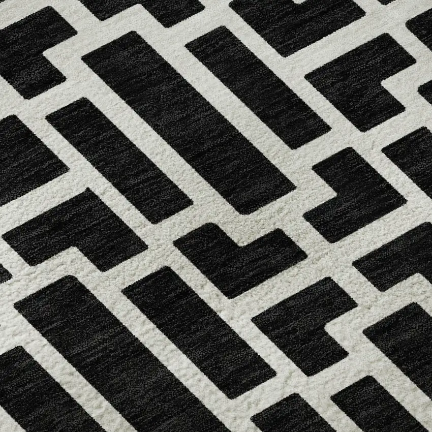 8' Black And Ivory Geometric Washable Round Rug With UV Protection Photo 9