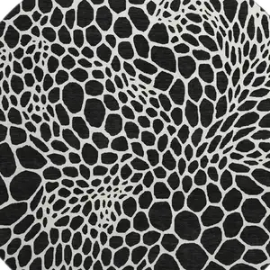 Photo of 8' Black And Ivory Geometric Washable Round Rug With UV Protection
