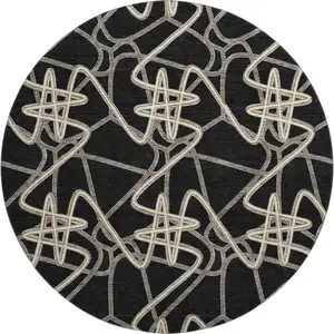 Photo of 8' Black And Ivory Geometric Washable Round Rug With UV Protection