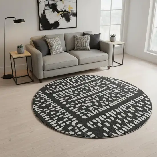 8' Black And Ivory Geometric Washable Round Rug With UV Protection Photo 2