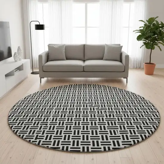 8' Black And Ivory Geometric Washable Round Rug With UV Protection Photo 2