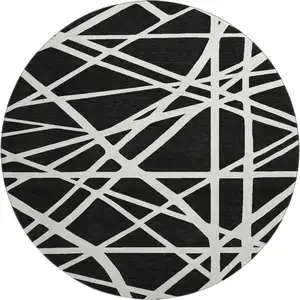 Photo of 8' Black And Ivory Geometric Washable Round Rug With UV Protection