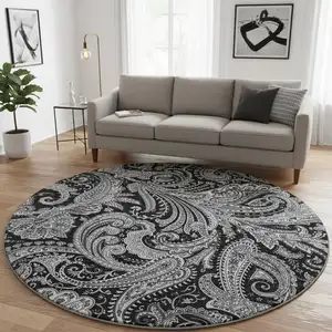 Photo of 8' Black And Ivory Paisley Washable Round Rug With UV Protection
