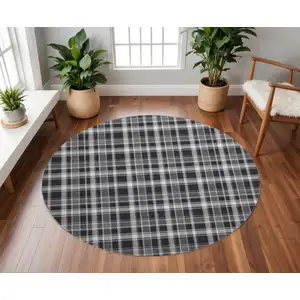 Photo of 8' Black And Ivory Plaid Washable Round Rug With UV Protection
