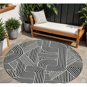 Photo of 8' Black And Ivory Round Abstract Washable Indoor Outdoor Area Rug