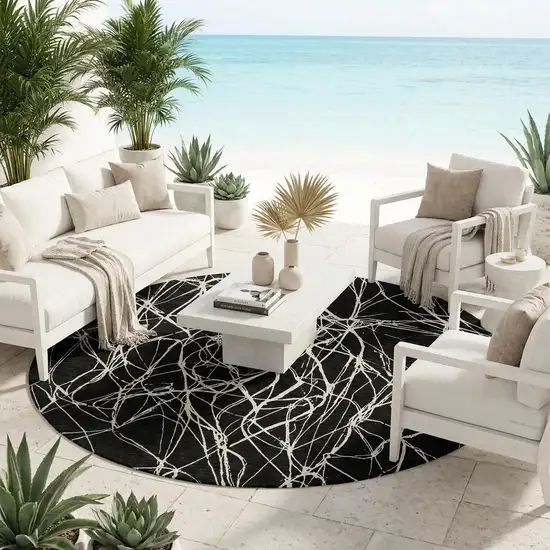 8' Black And Ivory Round Abstract Washable Indoor Outdoor Area Rug Photo 1
