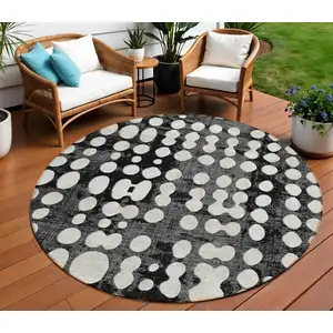 Photo of 8' Black And Ivory Round Abstract Washable Indoor Outdoor Area Rug