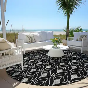 Photo of 8' Black And Ivory Round Geometric Washable Indoor Outdoor Area Rug