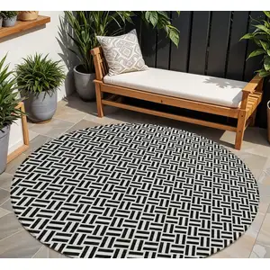 Photo of 8' Black And Ivory Round Geometric Washable Indoor Outdoor Area Rug