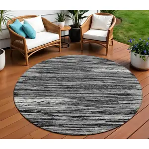 Photo of 8' Black And Ivory Round Striped Washable Indoor Outdoor Area Rug
