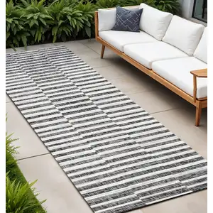 Photo of 8' Black And Ivory Striped Indoor Outdoor Runner Rug