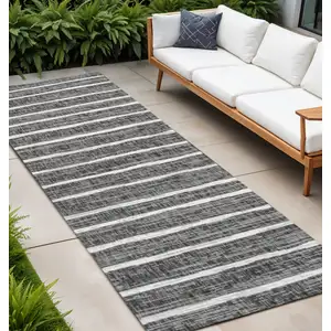 Photo of 10' Black And Ivory Striped Indoor Outdoor Runner Rug