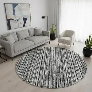 Photo of 8' Black And Ivory Striped Washable Round Rug With UV Protection