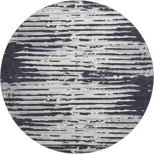 Photo of 8' Black And Ivory Striped Washable Round Rug With UV Protection