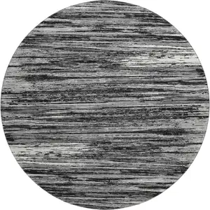 Photo of 8' Black And Ivory Striped Washable Round Rug With UV Protection