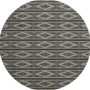 Photo of 8' Black And Taupe Geometric Washable Round Rug With UV Protection