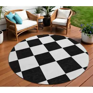 Photo of 8' Black And White Round Geometric Washable Indoor Outdoor Area Rug