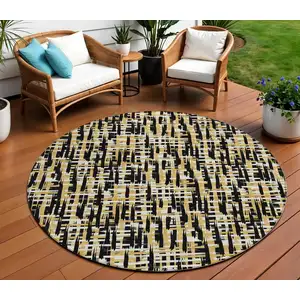Photo of 8' Black Gold And Ivory Round Abstract Washable Indoor Outdoor Area Rug