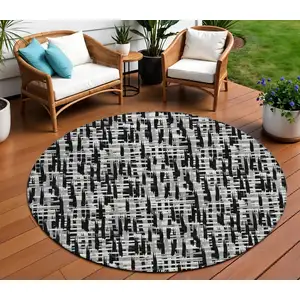 Photo of 8' Black Gray And Ivory Round Abstract Washable Indoor Outdoor Area Rug