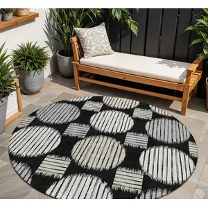 Photo of 8' Black Gray And Ivory Round Geometric Washable Indoor Outdoor Area Rug