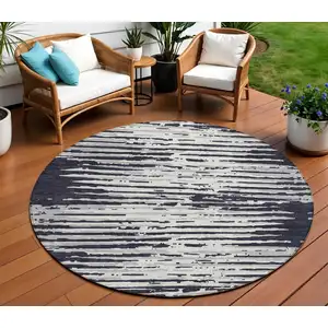 Photo of 8' Black Gray And Ivory Round Striped Washable Indoor Outdoor Area Rug