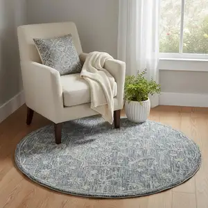 Photo of 5' Blue And Ivory Wool Floral Hand Tufted Round Rug