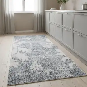 Photo of 8' Blue Floral Power Loom Worn Faded Runner Rug