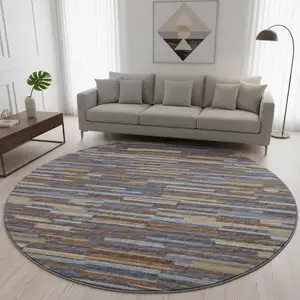 Photo of 8' Blue Gold And Brown Abstract Washable Round Rug With UV Protection