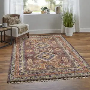 Photo of 10' Blue Red and Tan Wool Geometric Hand Knotted Runner Rug With Fringe