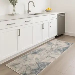Photo of 8' Blue Silver And Ivory Abstract Runner Rug