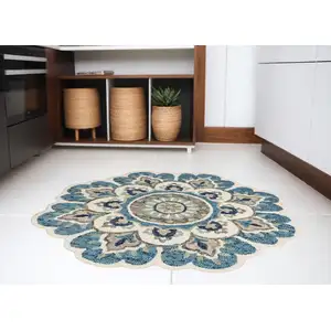 Photo of 5' Blue and Ivory Round Wool Floral Hand Tufted Area Rug