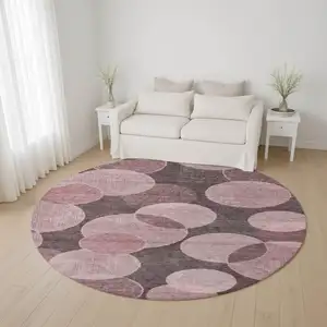 Photo of 8' Blush And Pink Geometric Washable Round Rug With UV Protection