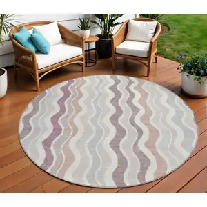Photo of 8' Blush Ivory And Taupe Round Striped Washable Indoor Outdoor Area Rug
