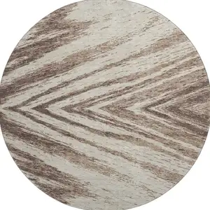 Photo of 8' Brown And Beige Abstract Washable Round Rug With UV Protection