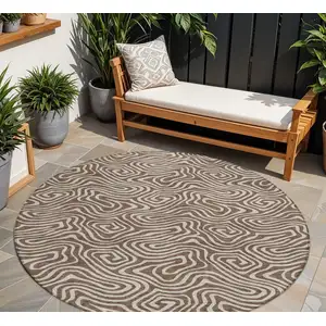 Photo of 8' Brown And Beige Round Abstract Washable Indoor Outdoor Area Rug