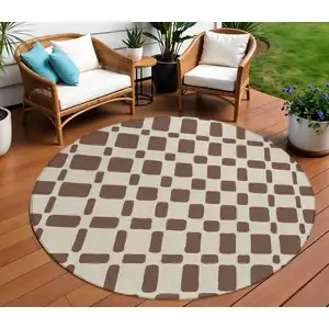 Photo of 8' Brown And Beige Round Geometric Washable Indoor Outdoor Area Rug