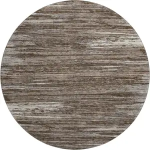 Photo of 8' Brown And Beige Striped Washable Round Rug With UV Protection