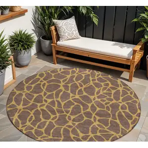 Photo of 8' Brown And Gold Round Geometric Washable Indoor Outdoor Area Rug