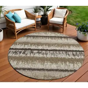 Photo of 8' Brown Beige And Ivory Round Striped Washable Indoor Outdoor Area Rug