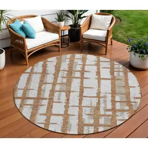 Photo of 8' Brown Beige And Ivory Round Striped Washable Indoor Outdoor Area Rug