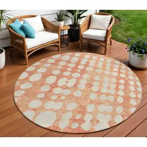 Photo of 8' Coral And Ivory Round Abstract Washable Indoor Outdoor Area Rug